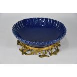 A 19th century Chinese monochrome blue-glazed pleated bowl on a French scrolling foliate ormolu stan