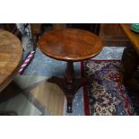 A Victorian cross banded flame mahogany tilt top occasional table