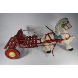 A child's pedal-car in the form of a horse and cart with slatted seat