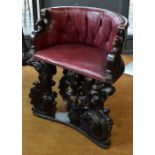 An antique carved oak demi-lune hall chair