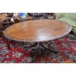 A George III mahogany breakfast table, oval tilt top