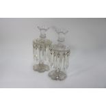 A pair of Victorian cut glass vases hung with prism lustres