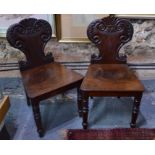 A pair of Victorian moulded shield back mahogany hall chairs