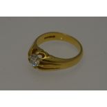 An 18ct yellow gold ring with single claw set brilliant cut diamond