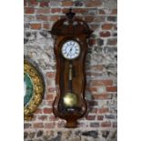 An antique walnut cased Vienna regulator clock