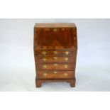 An 18th century diminutive feather banded walnut bureau