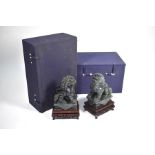 A pair of modern Chinese dark green hardstone figures of Buddhistic guardian lions