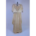An Edwardian lady's cream evening gown