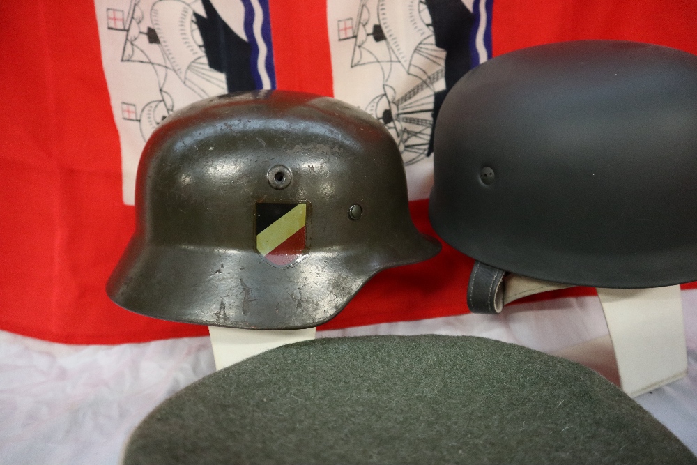 A German helmet, with shield transfers applied, together with another helmet, a peaked cap, a beret, - Image 4 of 7