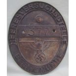 A World War II style brass / bronze wall plaque of oval form,