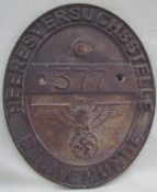 A World War II style brass / bronze wall plaque of oval form,