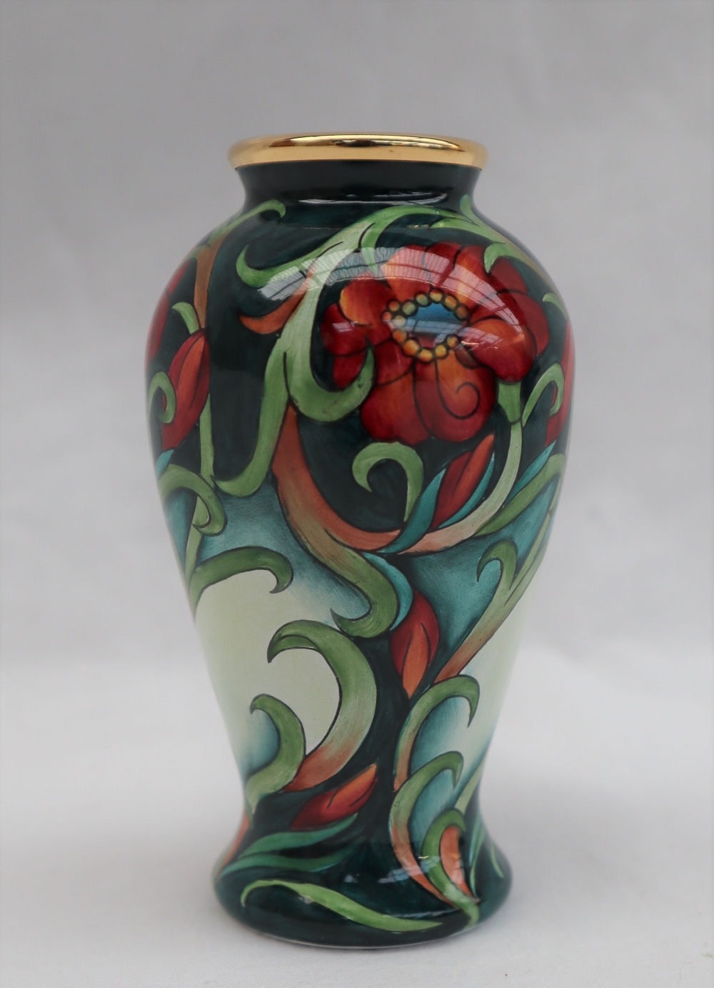 A Moorcroft enamels baluster vase, decorated with flowers and leaves to a green ground, - Image 2 of 5