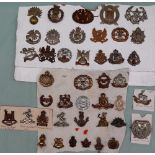A collection of circa forty two military cap badges including The Royal Warwickshire,