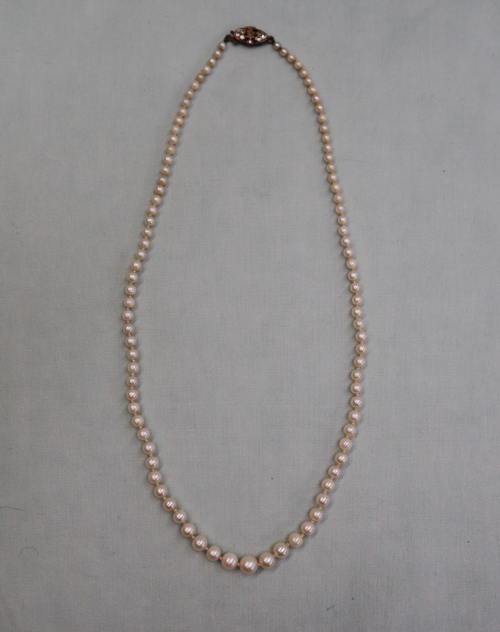 A pearl necklace, set with ninety five individually knotted pearls to a paste set clasp, 50cm long, - Image 3 of 3