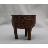 A Japanese bronze koro, cast to the rim with dogs of foo, on three legs,