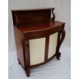 A Victorian mahogany chiffonier, with a raised shelf on scrolling supports, above a bowed top,