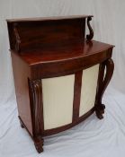 A Victorian mahogany chiffonier, with a raised shelf on scrolling supports, above a bowed top,