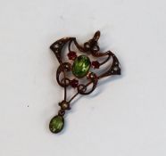 An Edwardian peridot, ruby and pearl set pendant, set with two oval faceted peridots,