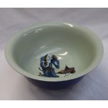 A large Chinese porcelain bowl with a blue ground, the interior decorated with a figure,