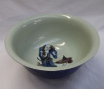 A large Chinese porcelain bowl with a blue ground, the interior decorated with a figure,