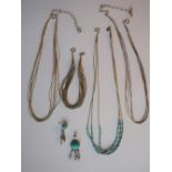 A silver and turquoise barrel bead set necklace together with a two other necklaces,