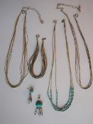 A silver and turquoise barrel bead set necklace together with a two other necklaces,