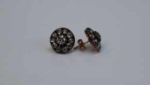 A pair of diamond cluster earrings, set with a central old round cut diamond approximately 0.
