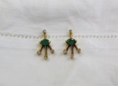 A pair of emerald and diamond earrings, of fan shape,