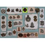 A collection of circa thirty five military cap badges including the Royal Highlanders,