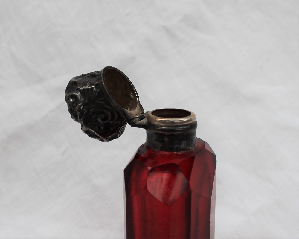 An Edwardian Silver topped and cranberry glass scent bottle, cast with leaves to a faceted body, - Image 2 of 6