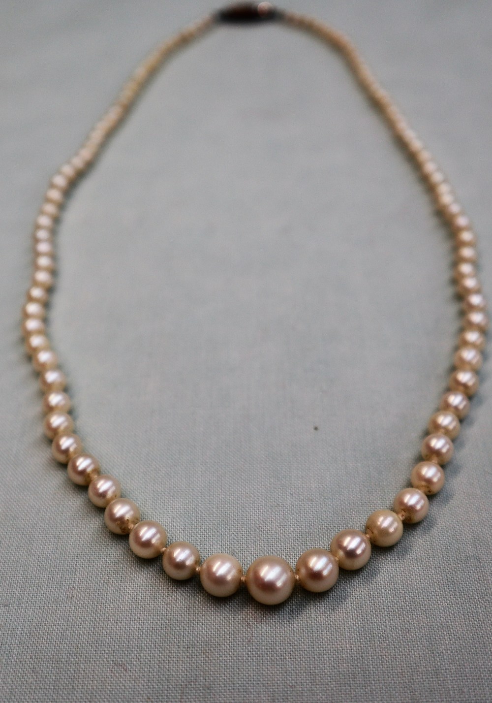 A pearl necklace, set with ninety five individually knotted pearls to a paste set clasp, 50cm long, - Image 2 of 3
