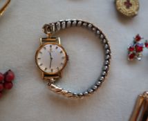 A Lady's Tissot wristwatch with a silvered dial and batons on an expanding bracelet strap together