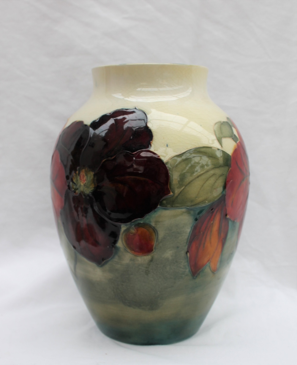 A Moorcroft Clematis pattern vase with a tapering neck to a cream ground, impressed mark, - Image 5 of 7