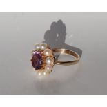 An amethyst and pearl ring, the central oval faceted amethyst approximately 10 x 8mm,