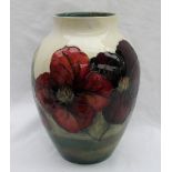 A Moorcroft Clematis pattern vase with a tapering neck to a cream ground, impressed mark,