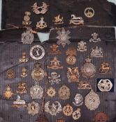 A collection of circa forty military cap badges including Royal Welsh Fusiliers,