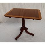 A George III mahogany tripod table with a crossbanded top on a snap action and baluster column with