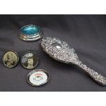 An Edwardian silver backed hand mirror, embossed with scrolling leaves, Sheffield, 1902,
