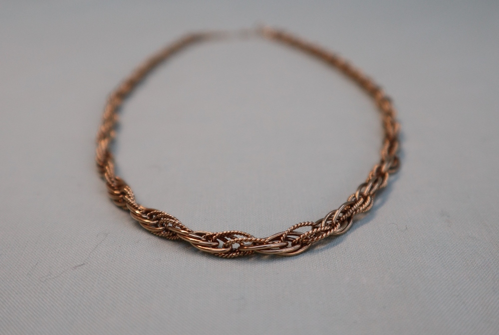 A 9ct yellow gold necklace, of rope twist form, with textured and smooth pointed oval links,