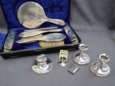 A George V silver dressing table set, comprising a hand mirror, pair of clothes brushes,