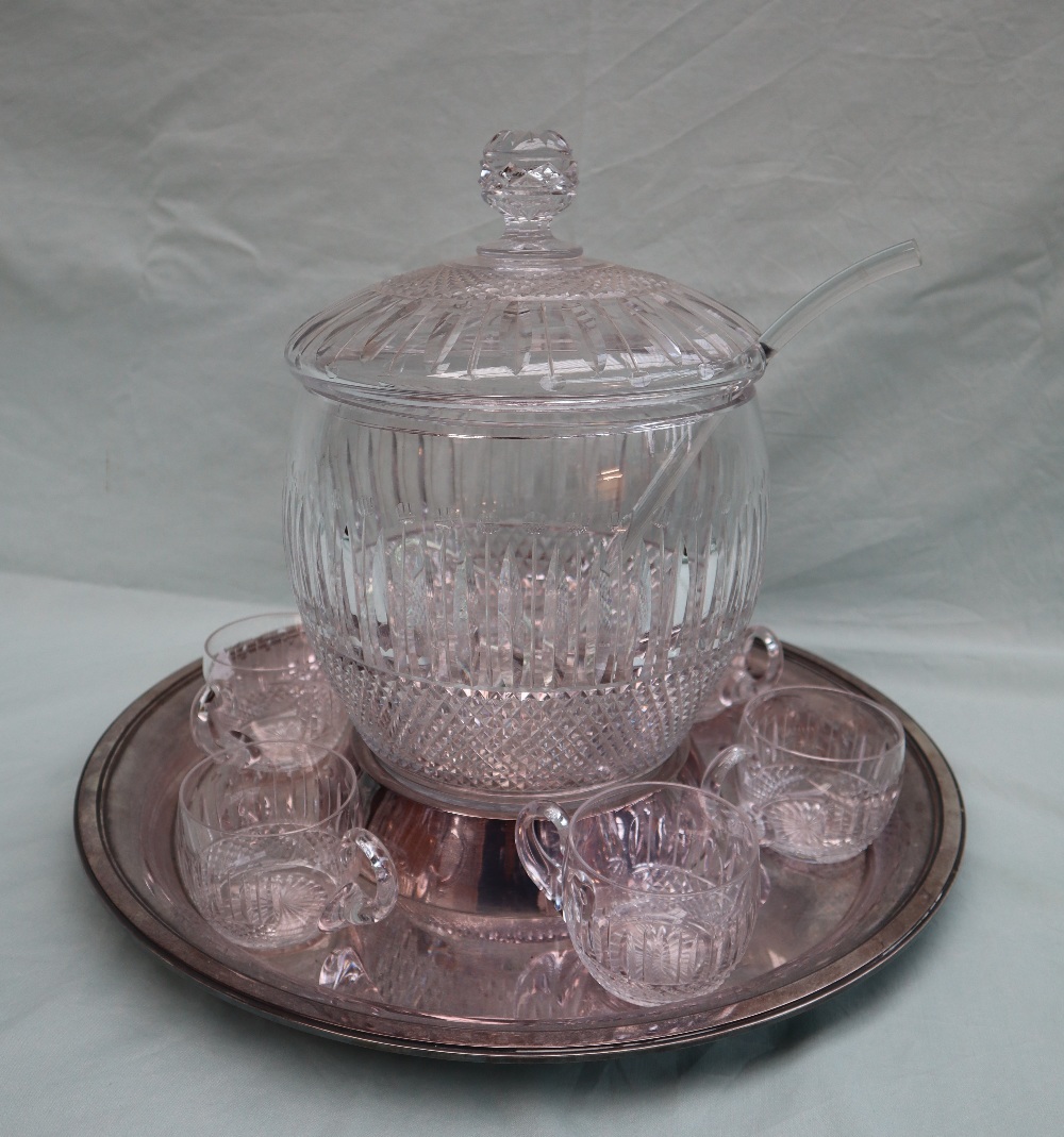A French crystal punch bowl with a domed lid, ladle and six glasses on an electroplated base,