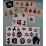 A collection of circa thirty five military cap badges including Highland Light Infantry,