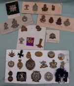 A collection of circa thirty five military cap badges including Highland Light Infantry,