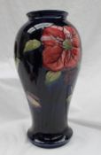 A large Moorcroft pottery Clematis pattern vase to a Royal blue ground, of inverted baluster form,