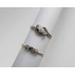 A three stone diamond ring, set with round old cut diamonds to a white metal setting, marked 18ct,