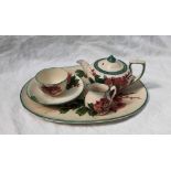 A Llanelly Art Pottery part cabaret set, comprising an oval tray, teapot, cream jug,