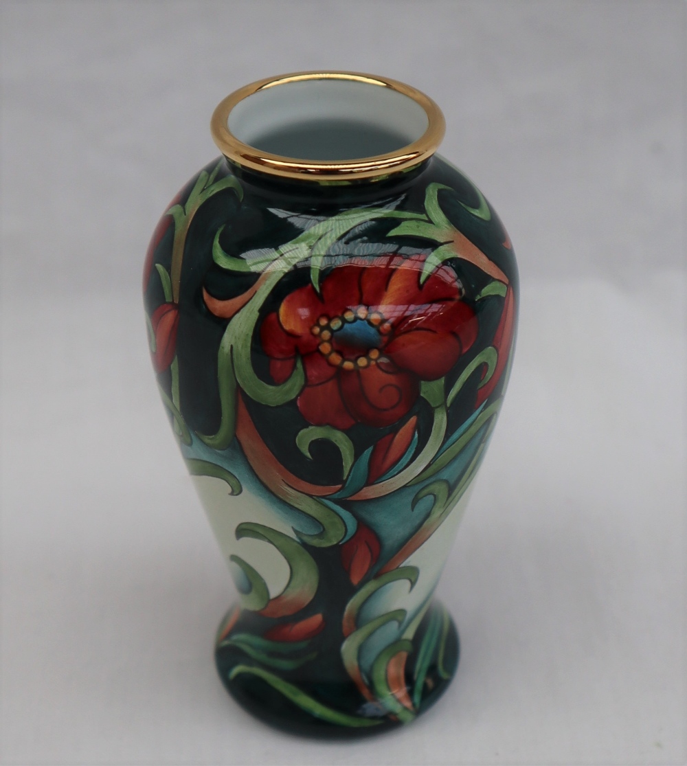 A Moorcroft enamels baluster vase, decorated with flowers and leaves to a green ground, - Image 3 of 5