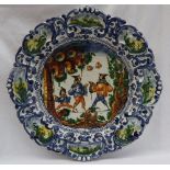An Italian Maiolica istoriato type charger, of shaped circular form,