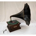 An oak cased gramophone, the case carved with flowerheads and leaves,