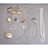 A silver locket on a chain, together with other silver chains,brooches,